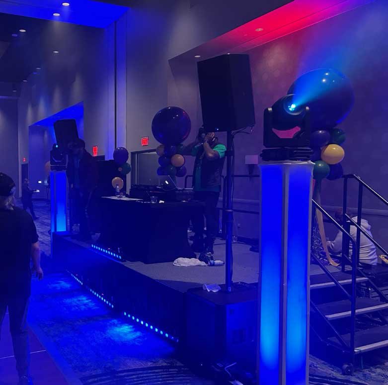 Professional DJ and MC engaging guests at a corporate or wedding event with high-energy music and professional hosting
