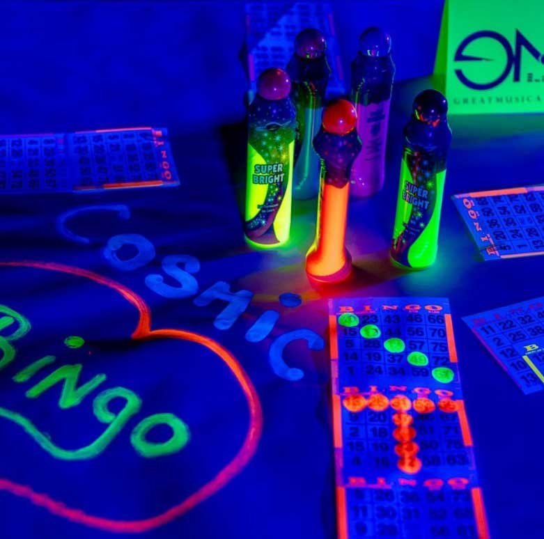 Guests playing Cosmic Bingo with neon lights and music at a corporate or social event in Dallas–Fort Worth