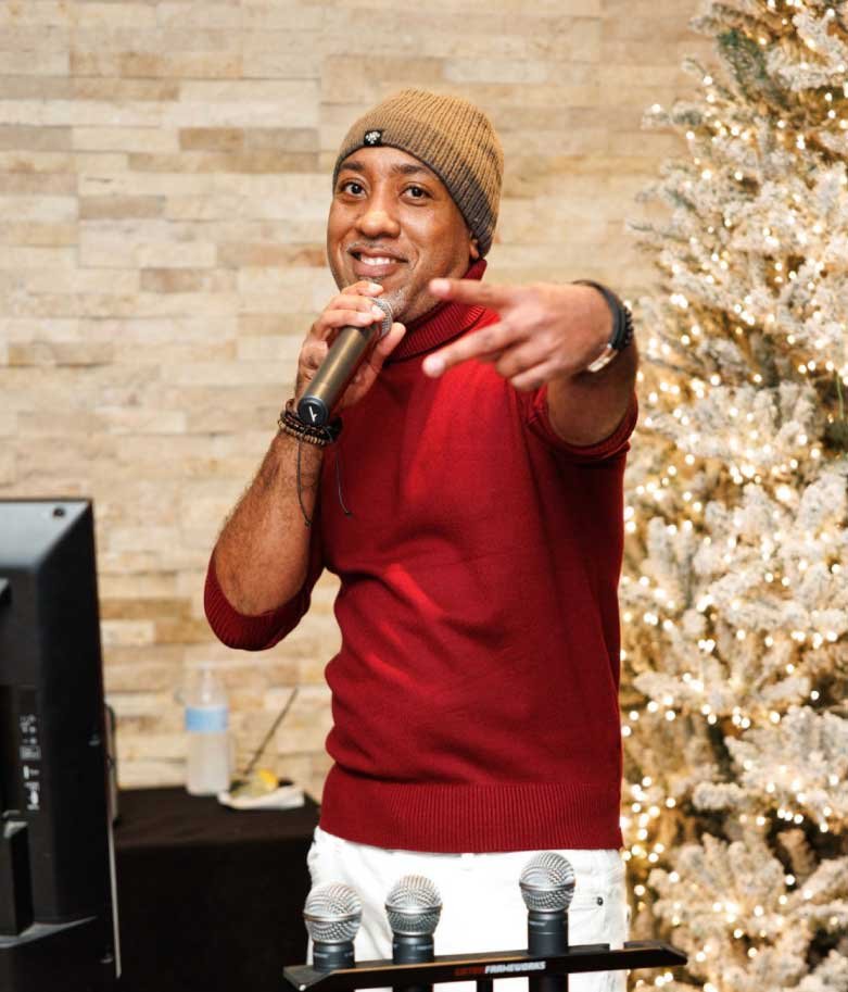 Professional DJ and MC engaging guests at a corporate or wedding event with high-energy music and professional hosting